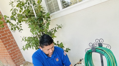 Plumber beside garden hose Photo